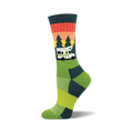 Crew socks in green, teal, and orange, featuring a retro camper van design against a sunset graphic with pine trees.