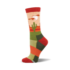 Crew socks in orange, green, and beige, with a desert landscape including a cactus and moon graphic.