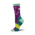 Crew socks in purple, teal, and lime green.  The main design is a pink butterfly and small flowers on a purple background.
