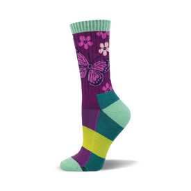 the sock is mostly dark purple with a light purple butterfly. the butterfly's wings have a dark purple outline and light purple and pink flowers with light green leaves. the sock also has light green, teal, and yellow accents at the top and bottom.