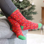 Flat lay product shot of a pair of green Christmas Lights socks. [lf]