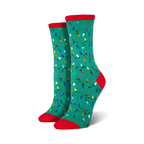 Lifestyle shot of a person wearing red Christmas Lights socks, sitting near a Christmas tree.