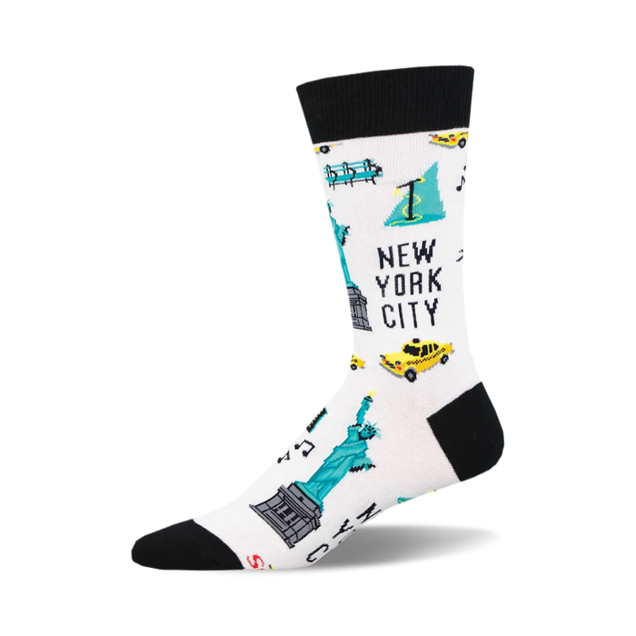 socks that are white with a pattern of various new york city landmarks and symbols. there are images of the statue of liberty, the empire state building, a yellow taxi, a subway train, and a fire hydrant. }}