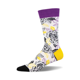 socks with a pattern of black and white roses with yellow centers and green leaves on a white background. the top of the sock is purple and the toe and heel are black.