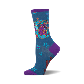 these socks are blue with a pattern of red and orange stars. there is a large purple crescent moon on the front of the sock with a cat sitting inside of it. the cat is black with purple eyes and is wearing a red hat with a star on it.