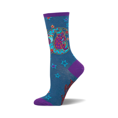 these socks are blue with a pattern of red and orange stars. there is a large purple crescent moon on the front of the sock with a cat sitting inside of it. the cat is black with purple eyes and is wearing a red hat with a star on it.