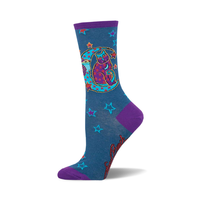 these socks are blue with a pattern of red and orange stars. there is a large purple crescent moon on the front of the sock with a cat sitting inside of it. the cat is black with purple eyes and is wearing a red hat with a star on it. }}