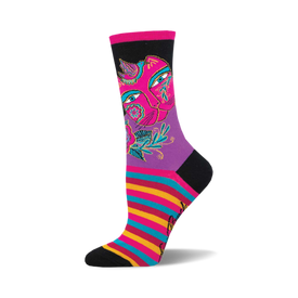socks that are black, purple, pink, blue, yellow and red. they have a pattern of a cat's face with flowers and birds on it. the cat's face is split in half with one half being a lighter shade of pink than the other half. the eyes are blue and the nose is black. the flowers are pink, yellow, and blue. the leaves are green. the birds are blue and yellow. the socks also have a striped pattern of pink, blue, yellow and red at the end of the sock by the toes.