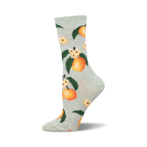 A pair of light green crew socks adorned with a repeating pattern of ripe peaches, green leaves, and delicate white flowers.