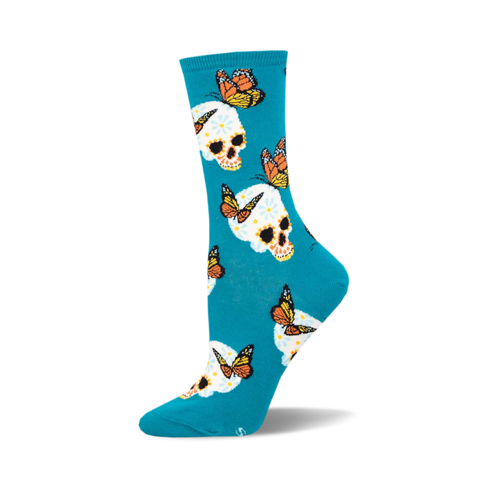 the blue socks have an all-over pattern of white skulls with pink, yellow, and orange flowers on them. there are also monarch butterflies in various positions around the skulls. }}