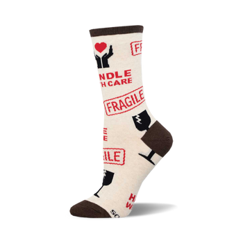 socks that are white with brown toes, heels, and cuffs. they have a pattern of red and black text and symbols, including the words 'handle with care', 'fragile', and 'this side up'. there is also a picture of a heart with hands holding it, and a picture of a wine glass with a line through it.