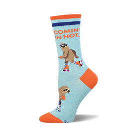 socks that are light blue with an orange toe, heel, and cuff. they have a pattern of sloths on roller skates. the sloths are wearing helmets and knee pads. the text "comin' in hot" is printed on the cuff in orange and blue.