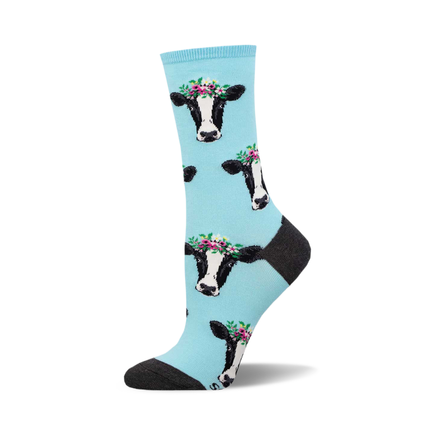 Crew socks featuring a light blue background and repeated pattern of black and white cows wearing flower crowns.