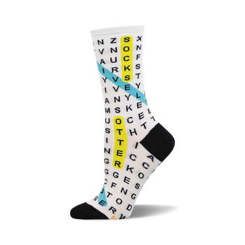the white socks have a word search puzzle printed in black ink all over. there is a blue and yellow diagonal line going through the word search. the words in the word search are related to the theme of socks.