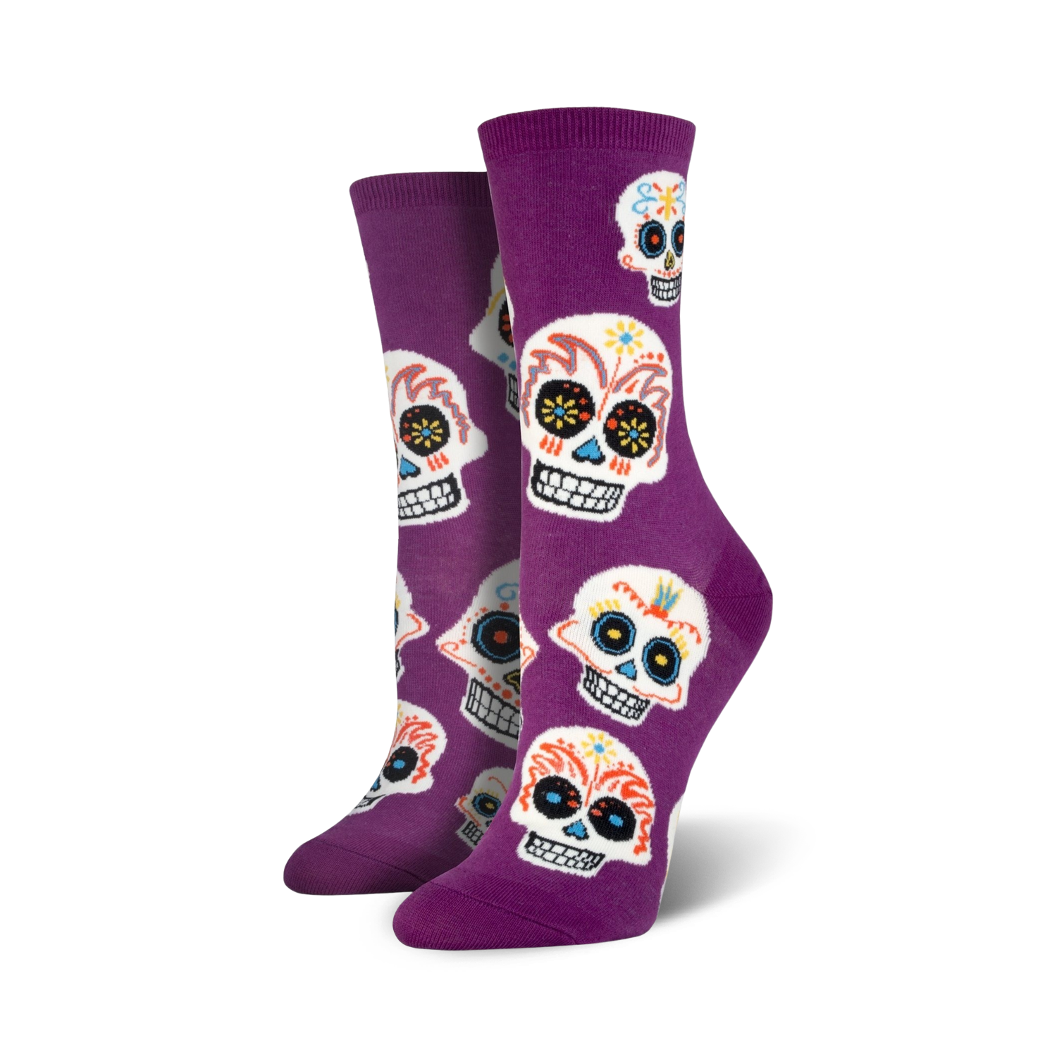 A pair of women's crew socks in purple with a fun pattern of colorful sugar skulls. Perfect for Dia de los Muertos!
