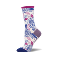 A pair of cream crew socks adorned with a vibrant print of purple and blue roses and leaves. The socks have purple and blue accents at the heel and toe.