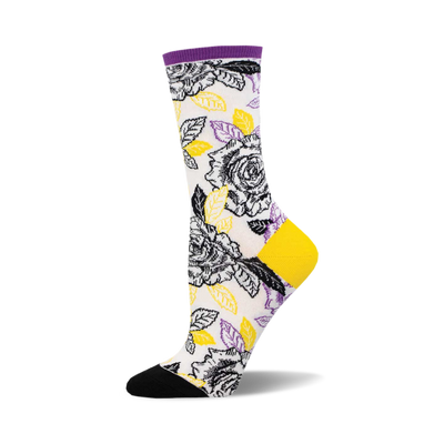 socks that are white with a pattern of black and yellow roses and green leaves. the toes and heels of socks that are black and the tops are purple.