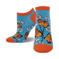 A pair of teal ankle socks adorned with orange monarch butterflies and white daisies. The socks have orange cuffs.