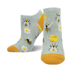 A pair of light blue ankle socks with a fun bee design.  Yellow bees, daisies, and honeycombs are featured on the socks, which have a mustard yellow cuff.