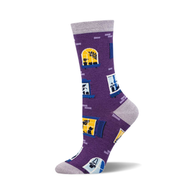 the window cats bamboo socks are purple with a pattern of blue and yellow windows. the windows have cats in them.