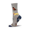 Grey crew socks with repeating images of chocolate, yellow, and black Labradors wearing bandanas.  The socks have a navy blue heel and toe.