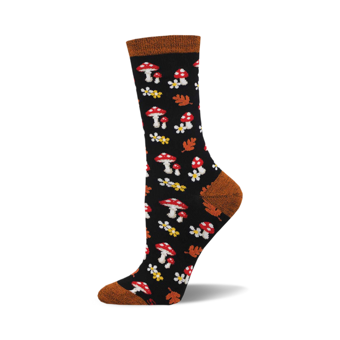the sock is black with an allover pattern of red and orange mushrooms, white and yellow flowers, and brown and orange leaves. the cuff is brown with a geometric pattern in orange. the heel and toe are brown.