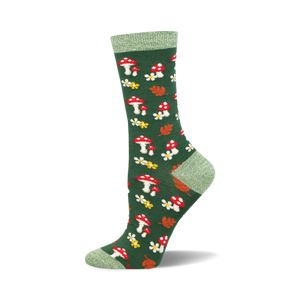 the sock is green with an all over pattern of red and white mushrooms, yellow flowers with white centers, and orange and red leaves. the top of the sock is solid green.
