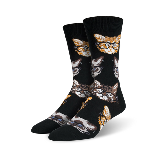 A pair of black crew socks with a repeating pattern of cats wearing glasses. The cats are orange, brown, and gray.