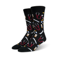 Pair of black crew socks with an all-over print of red stethoscopes, syringes, and pills.  Fun and quirky medical-themed design.