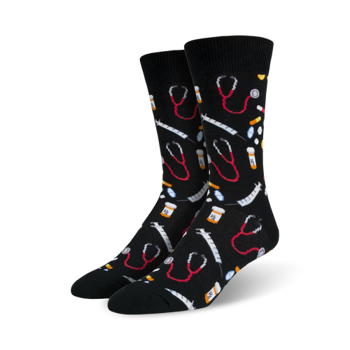 Pair of black crew socks with an all-over print of red stethoscopes, syringes, and pills.  Fun and quirky medical-themed design.