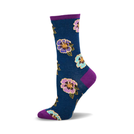 a blue sock with purple, pink, and blue flowers on it. the sock has a purple cuff.