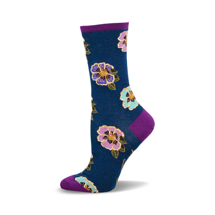 a blue sock with purple, pink, and blue flowers on it. the sock has a purple cuff. }}