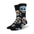 Pair of black crew socks with a colorful sugar skull pattern.  Orange, blue, and yellow details on the skulls against a black background.
