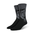 A pair of men's crew socks in black and gray, featuring a stylized grayscale portrait of John F. Kennedy.