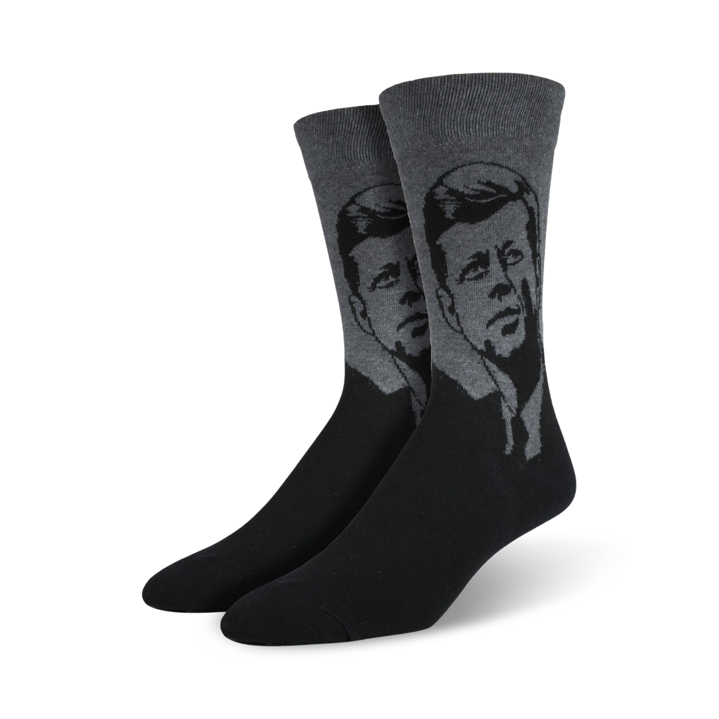 A pair of men's crew socks in black and gray, featuring a stylized grayscale portrait of John F. Kennedy.