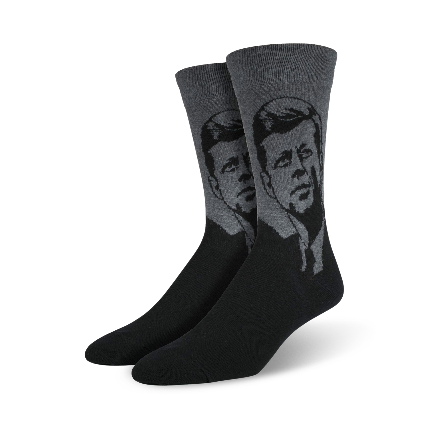 A pair of men's crew socks in black and gray, featuring a stylized grayscale portrait of John F. Kennedy.