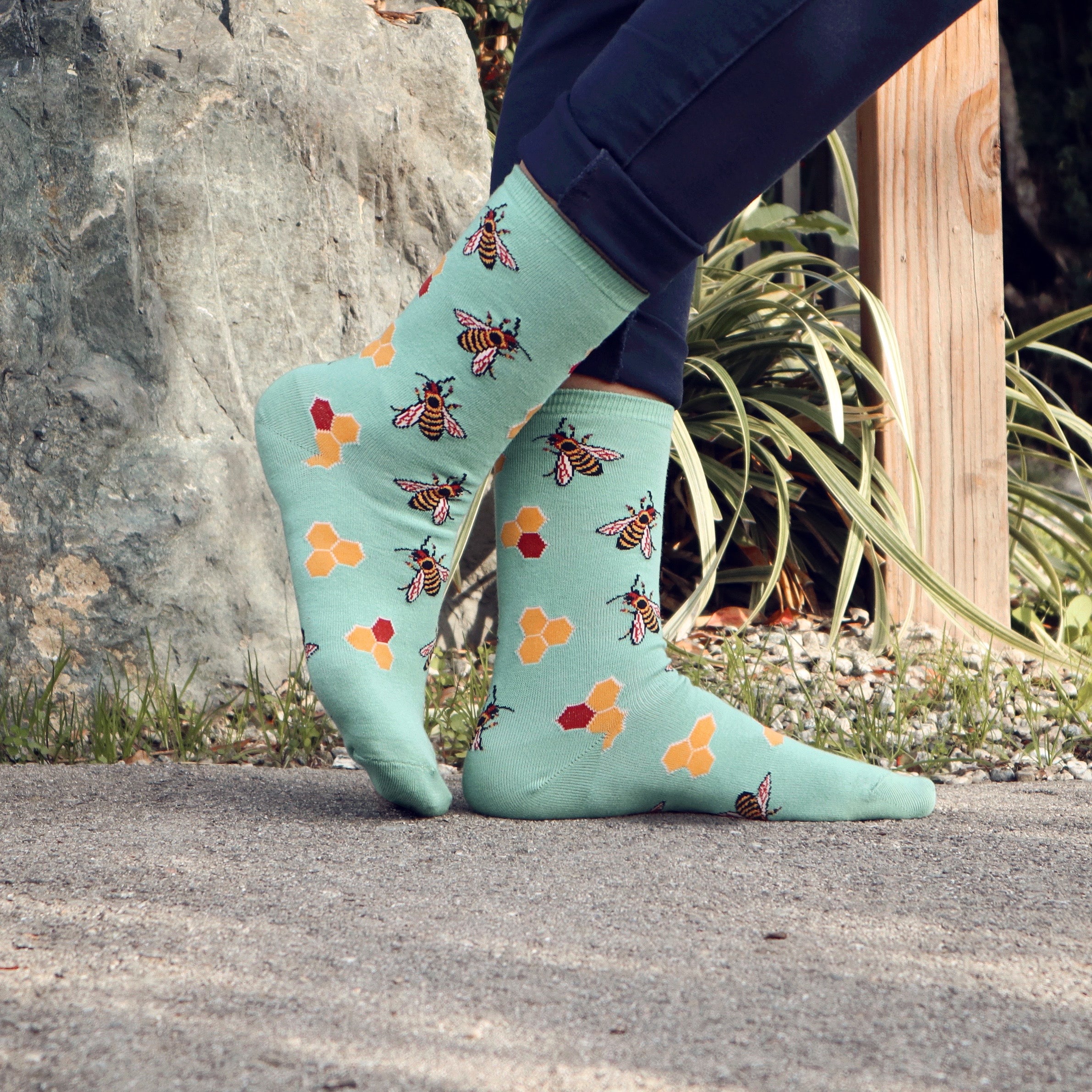 Flat lay image showcasing both the brown and mint green Busy Bees socks. [lf]