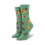 Lifestyle shot of a person wearing the mint green Busy Bees socks.