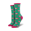 Pair of crew socks in teal with a repeating pattern of pink pigs. Pink cuffs.