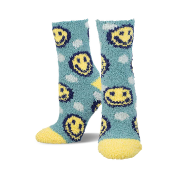 a pair of blue fuzzy socks with yellow smiley faces.