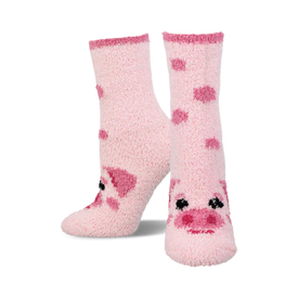 pair of pink fuzzy socks with a pig face design.