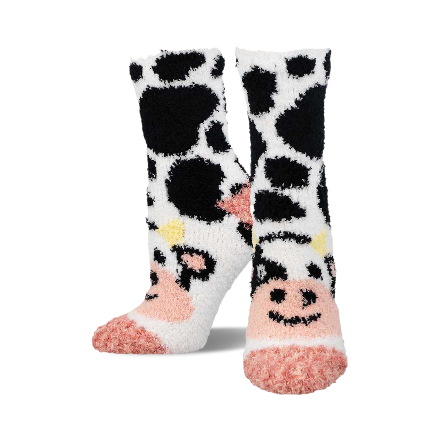 Pair of fuzzy crew socks featuring a black and white cow pattern with pink accents.  The toes are a solid pink.