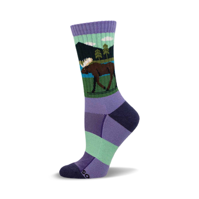 Crew socks with a lavender cuff. Design shows a brown moose, green trees, blue lake, dark green mountains, and white clouds.
