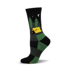 Crew socks in black and green featuring a campsite scene with a bear in a tent, trees, and a crescent moon at night.