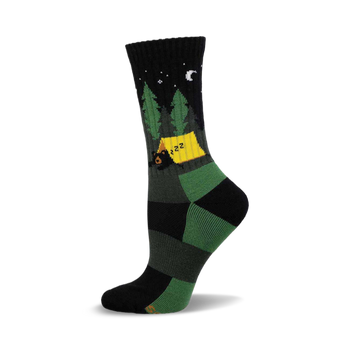 Crew sock with a black upper, featuring a starry night sky, green pine trees, a yellow tent, and a sleeping black bear.