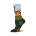 Crew socks in teal, olive, and light blue, featuring a whimsical illustration of a fox, hare, and bird in a forest scene.
