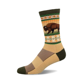 a tan sock with a green and orange patterned band featuring a brown bison.  the sock is laying on a black surface.