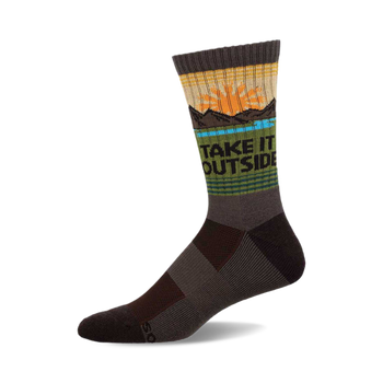 a gray sock with a design on it that says "take it outside". the design includes a setting sun, a blue lake, and some mountains.