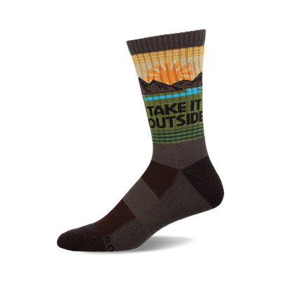 a gray sock with a design on it that says "take it outside". the design includes a setting sun, a blue lake, and some mountains.