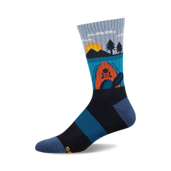 a blue, black, and orange patterned sock with a sunset scene and a kayak.